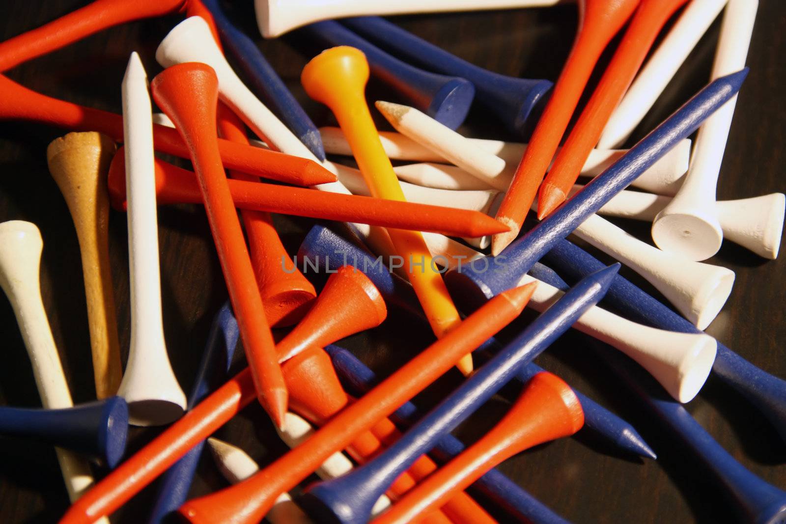 Colored golf tees in a pile 