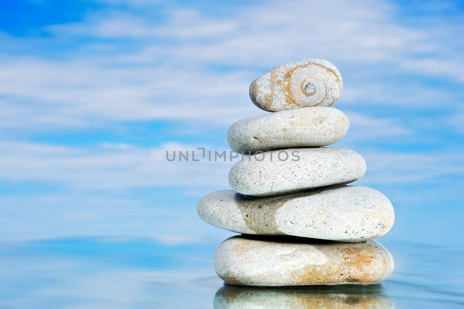 Pile of a sea pebble against clouds and the sea