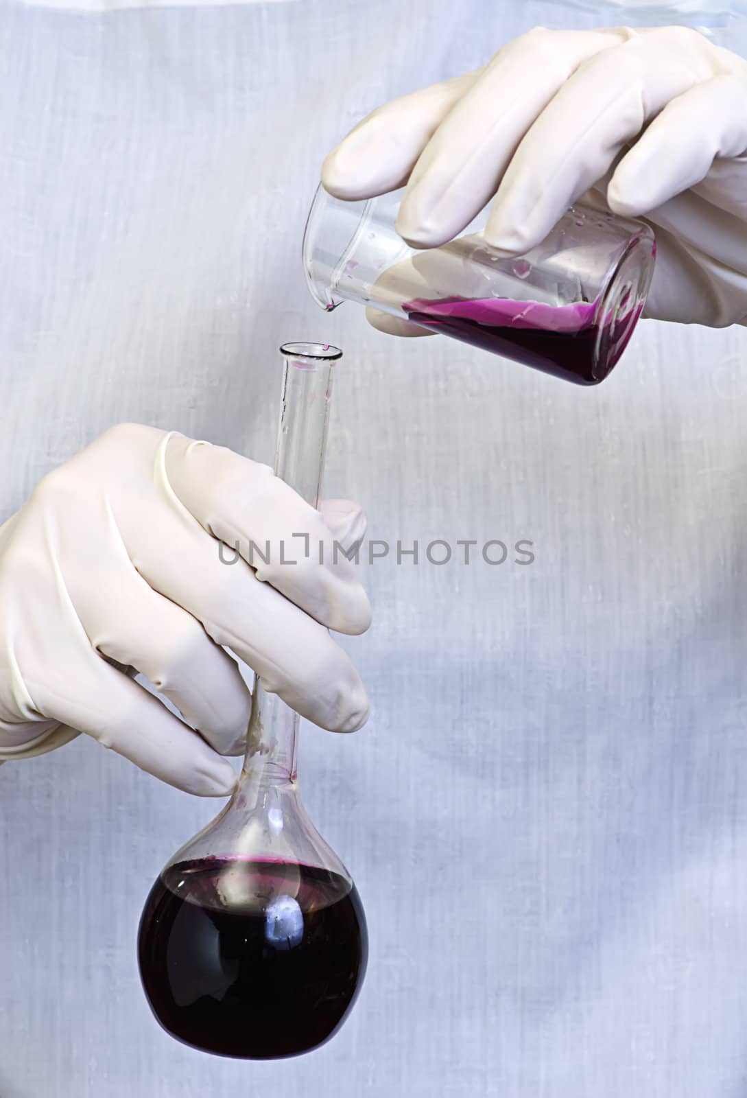 hands with laboratory glassware on white,