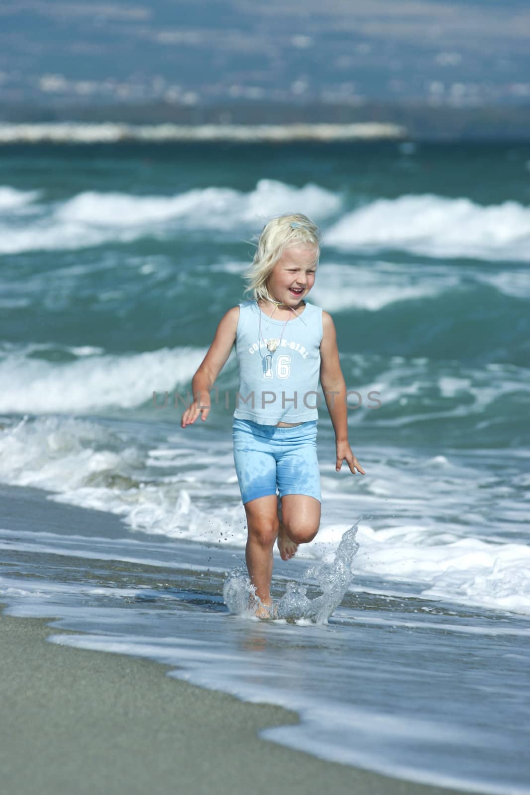 Little girl running on the beach