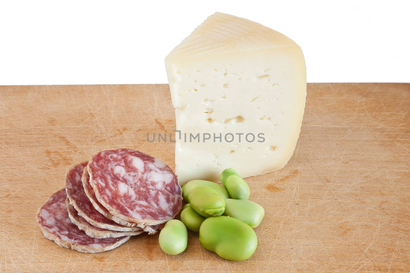 cutting board with salami pecorino and broad beans isolated on white background with clipping path
