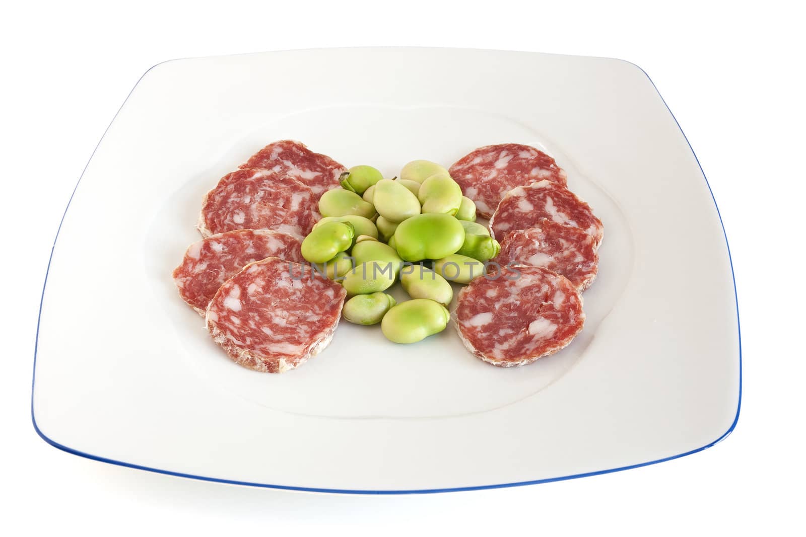 broad beans and salami sliced on a white plate isolated with clipping path