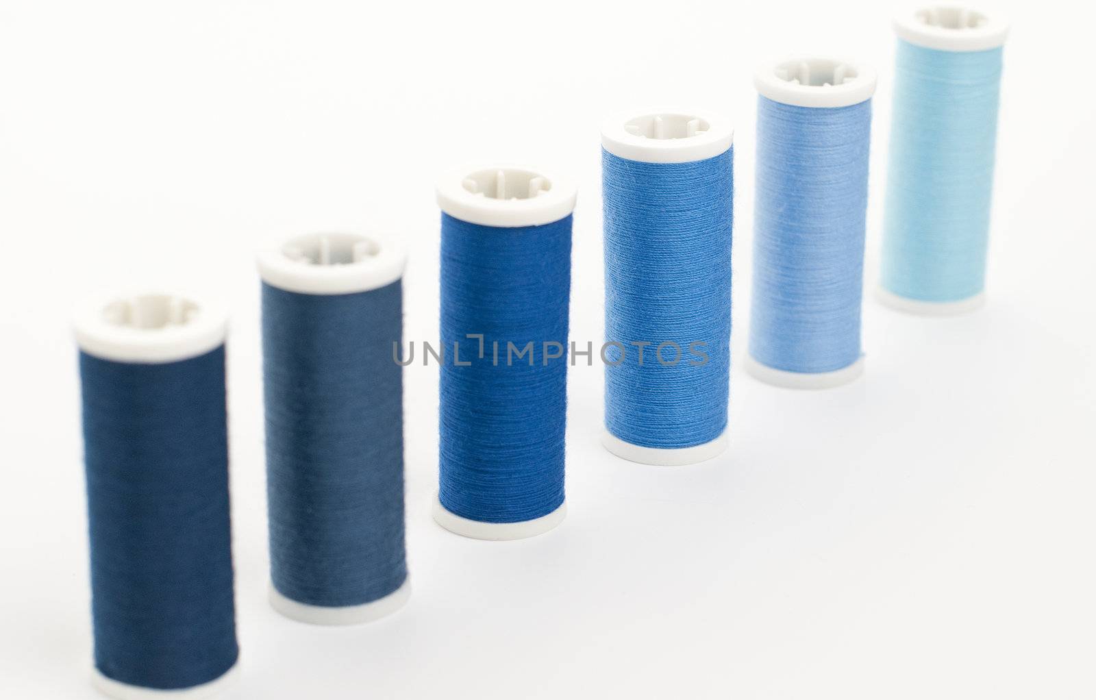Colorful Spools of sewing thread isolated on white background.
