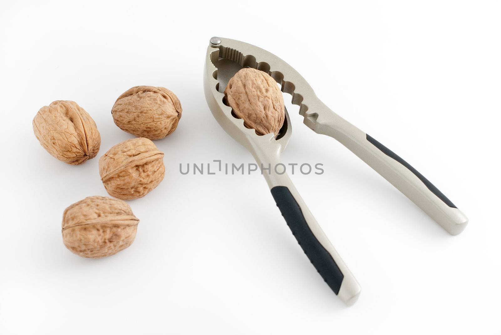 Food background, macro shot of a group of walnuts and a nutcracker.
