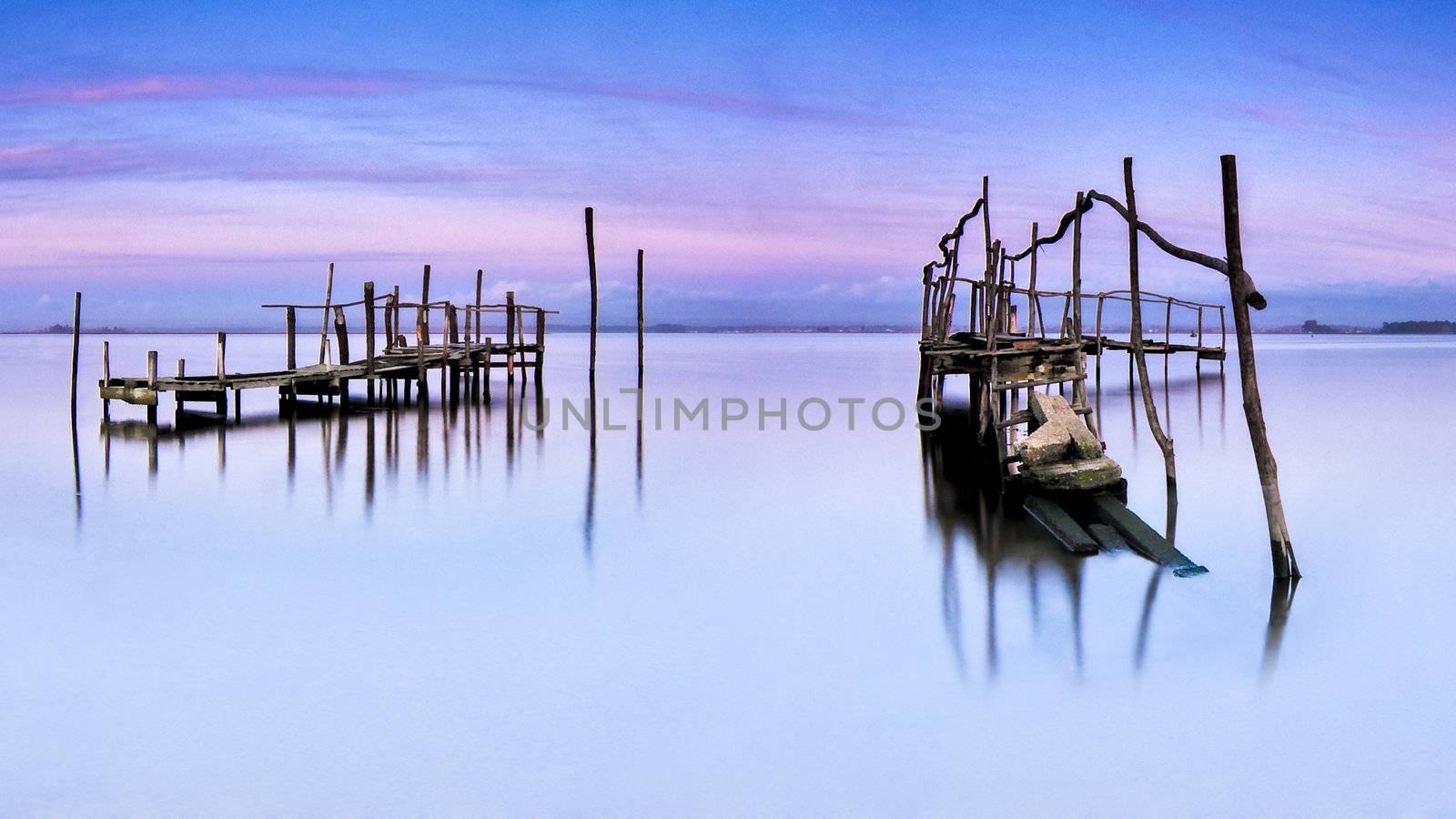 Fishing piers on a quiet water landscape.