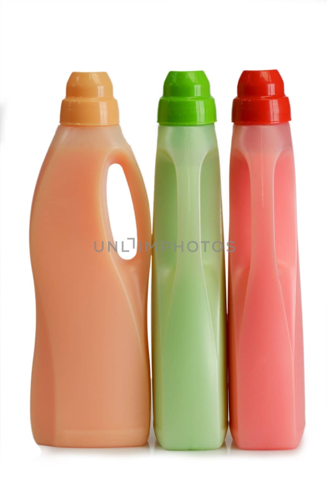 Bottles of laundry detergent and fabric softener on a white background