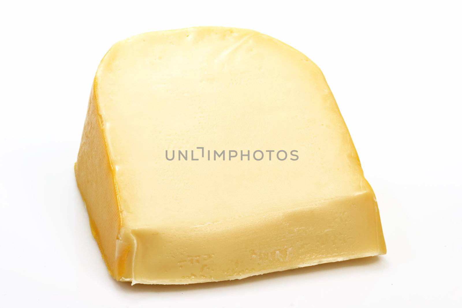 A big chunk of gouda cheese on bright background