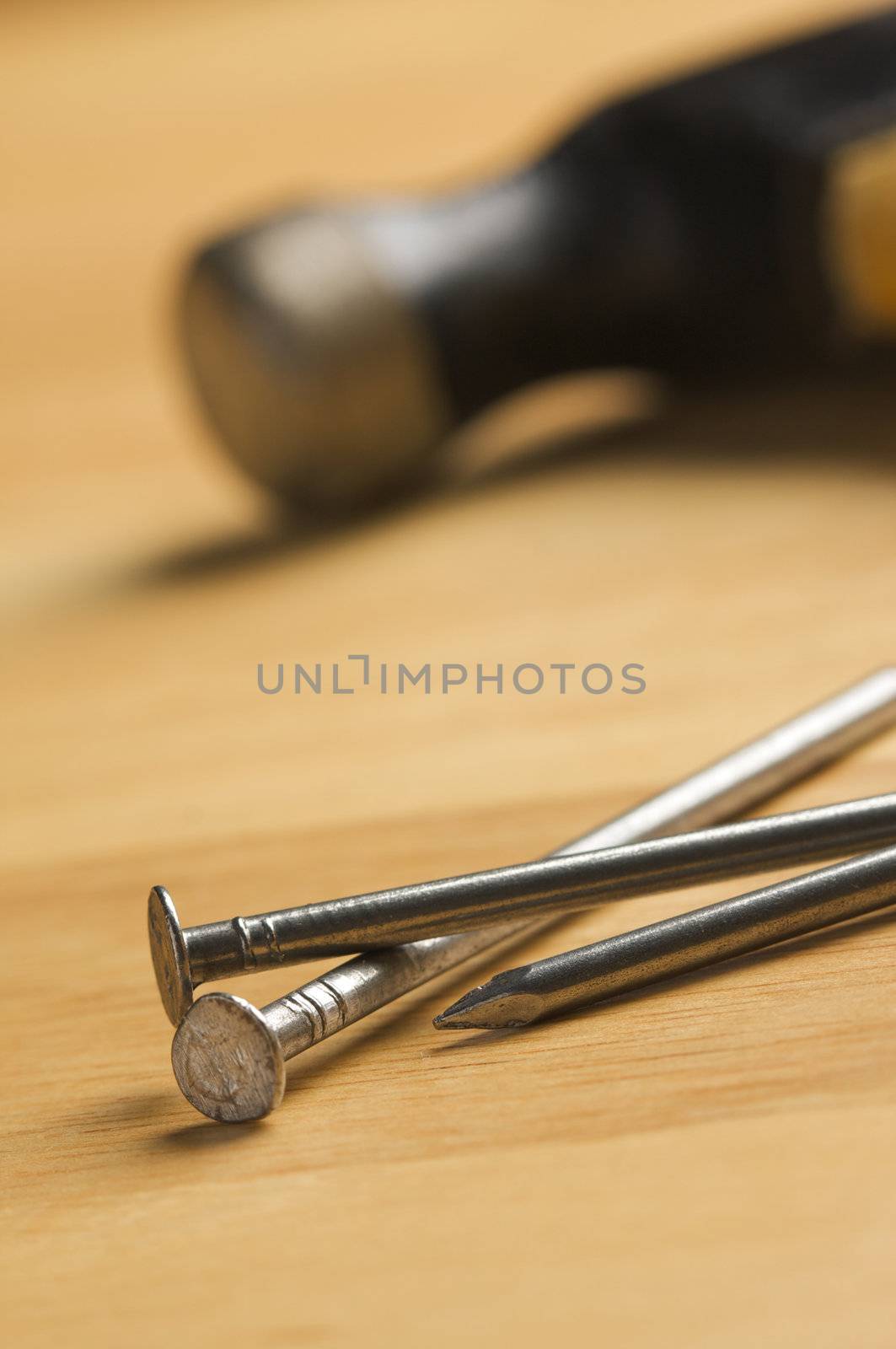 Hammer and Nails Abstract on Wood Background.