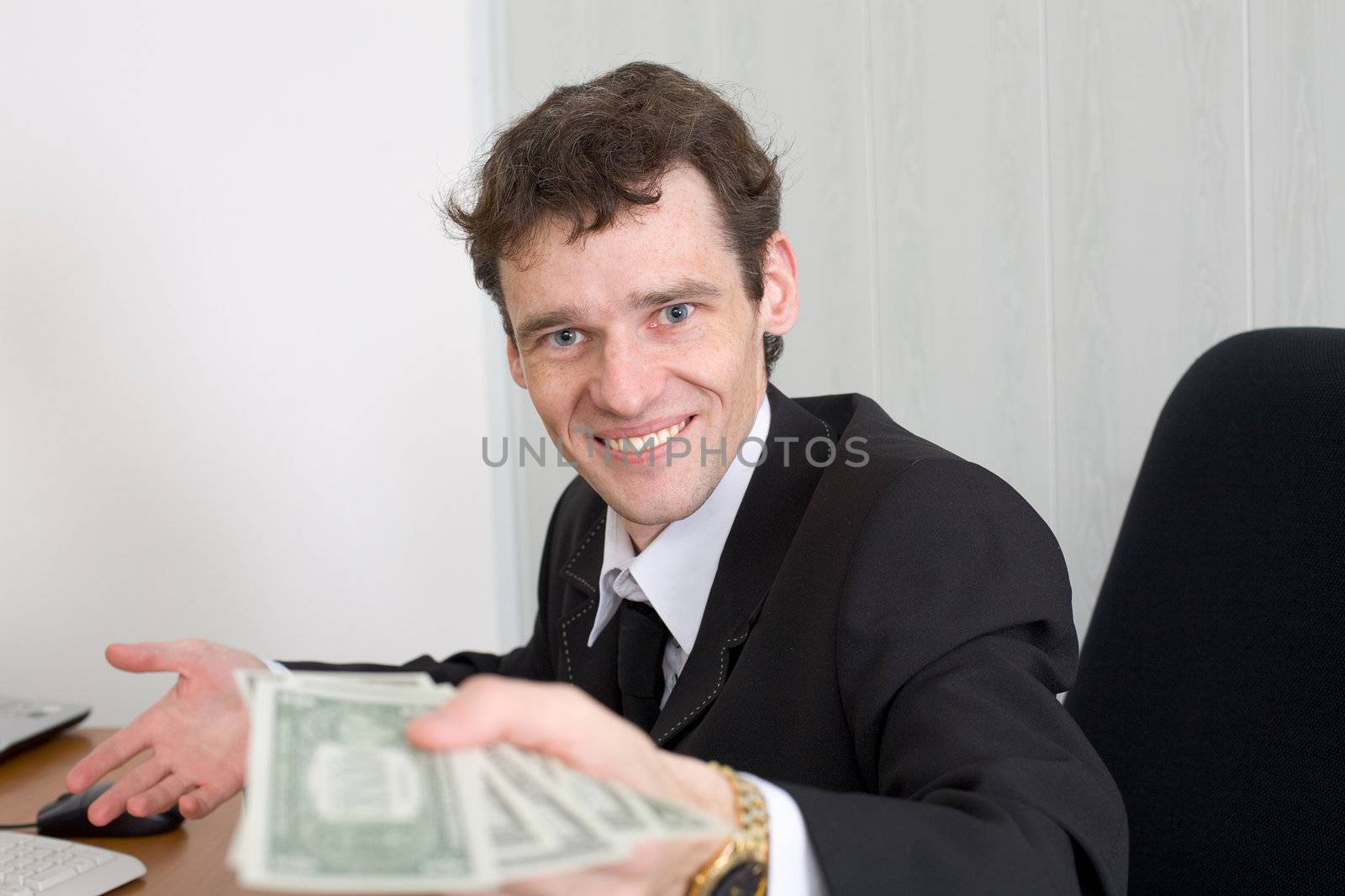The happy man stretches a pack of dollars