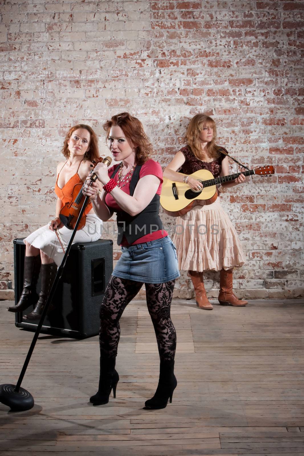 All girl band performing in stylish clothing 