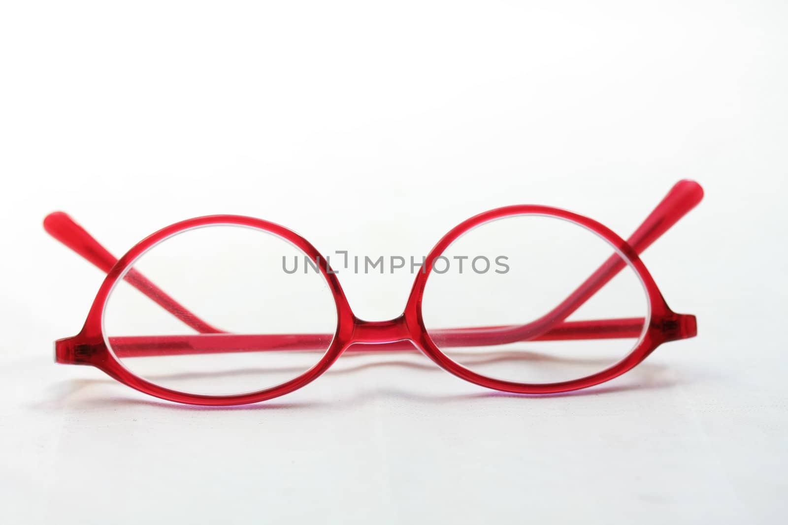 A pair of glasses, red pink plastic, presription glasses