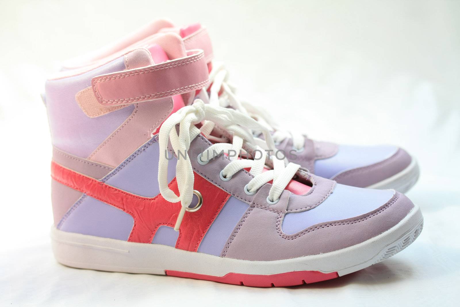 A pair of fashionable sneakers, pink and lila