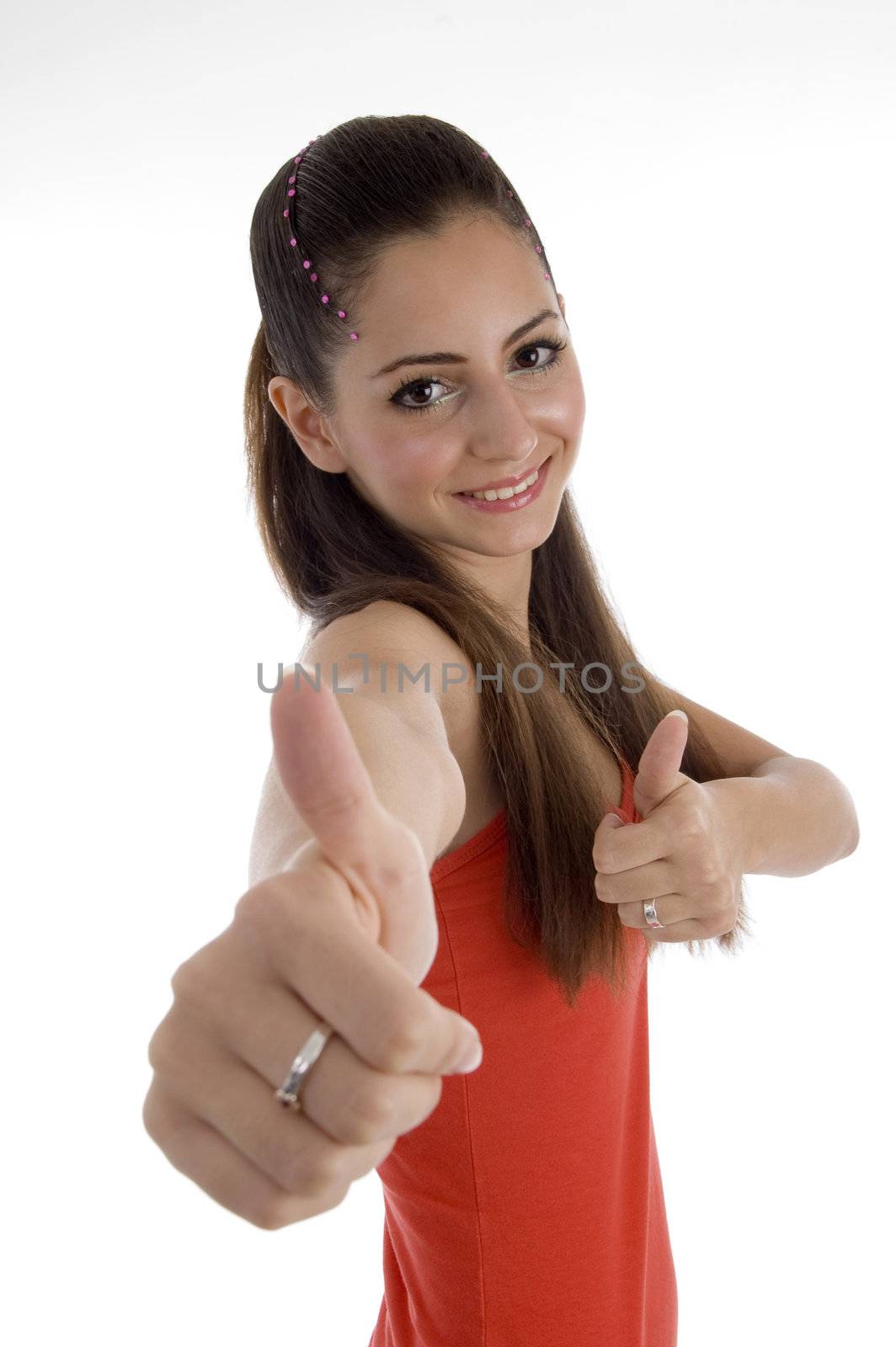 smiling girl with beautiful hairstyle showing thumb gesture by imagerymajestic