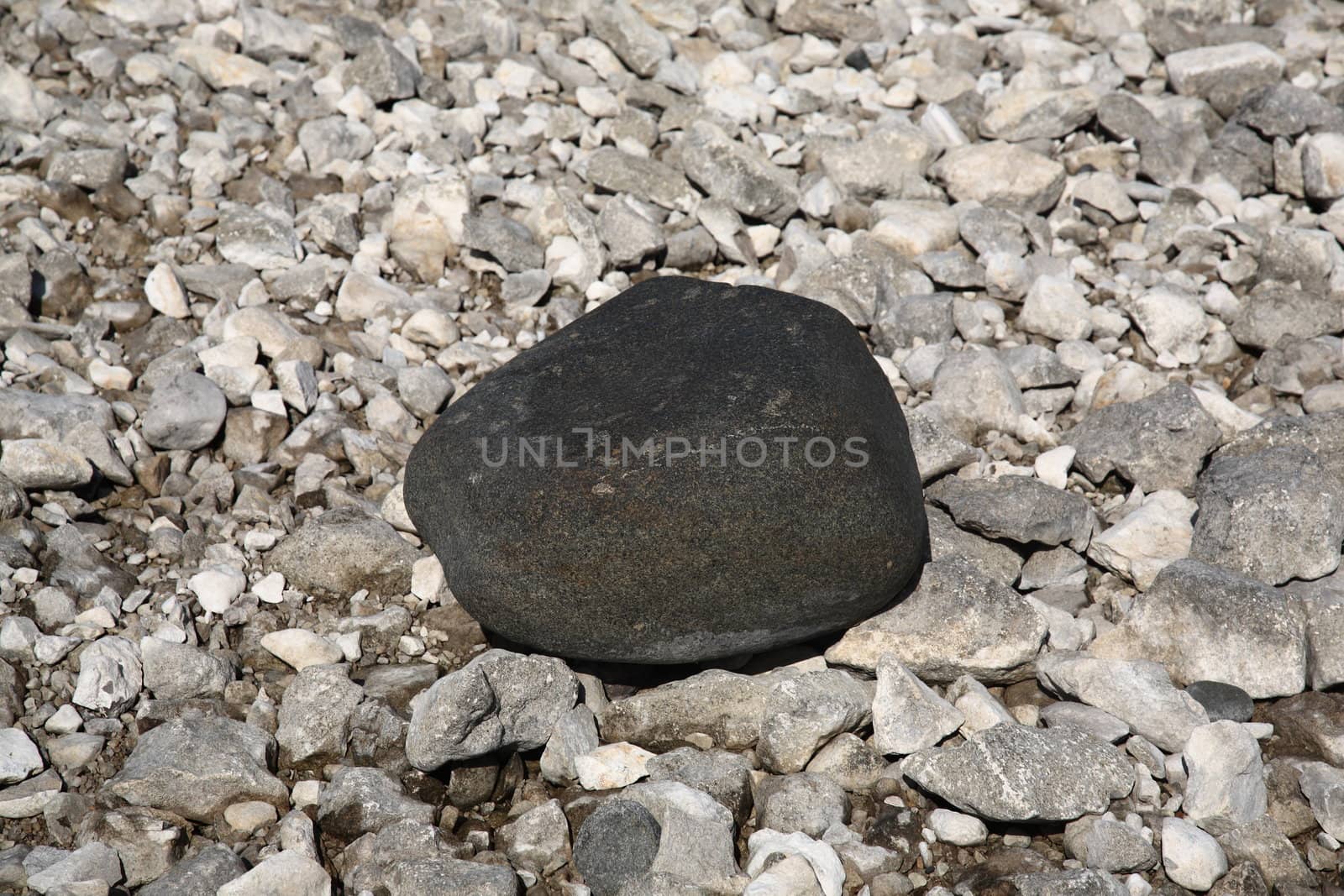 Black rock and white stones on a Lake Huron Beach