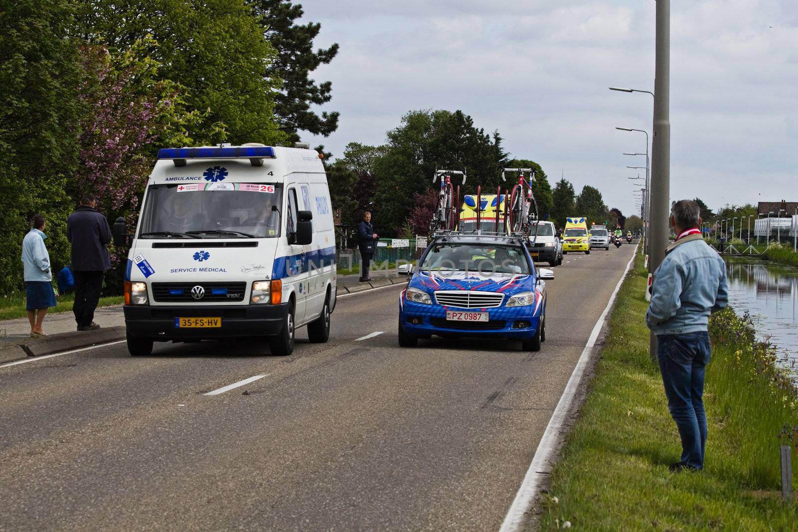 DELFGAUW, NETHERLANDS - MAY 10: Competitors and following teams in the Giro d�Italia passing by on a polderroad in the 3th stage of the competition on May 20, 2010, Delfgauw, the Netherlands. 