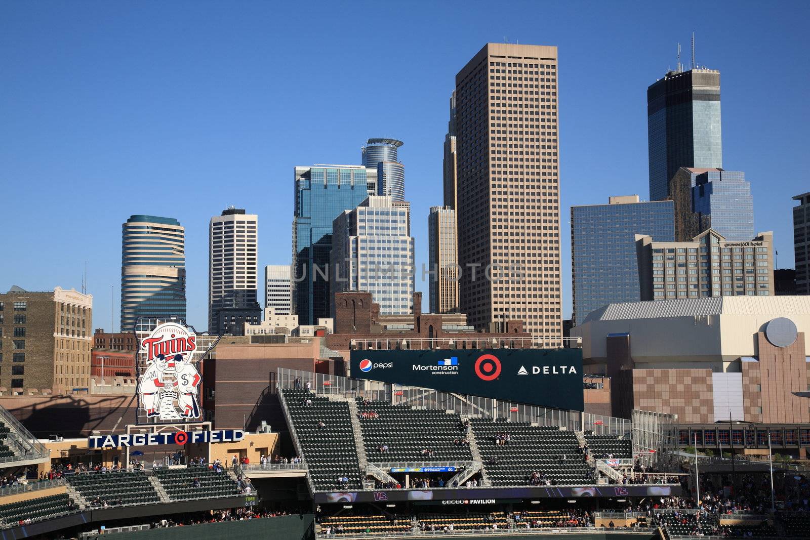 Classic Twins logo installed at new outdoor stadium, with Minneapolis skyscrapers in background