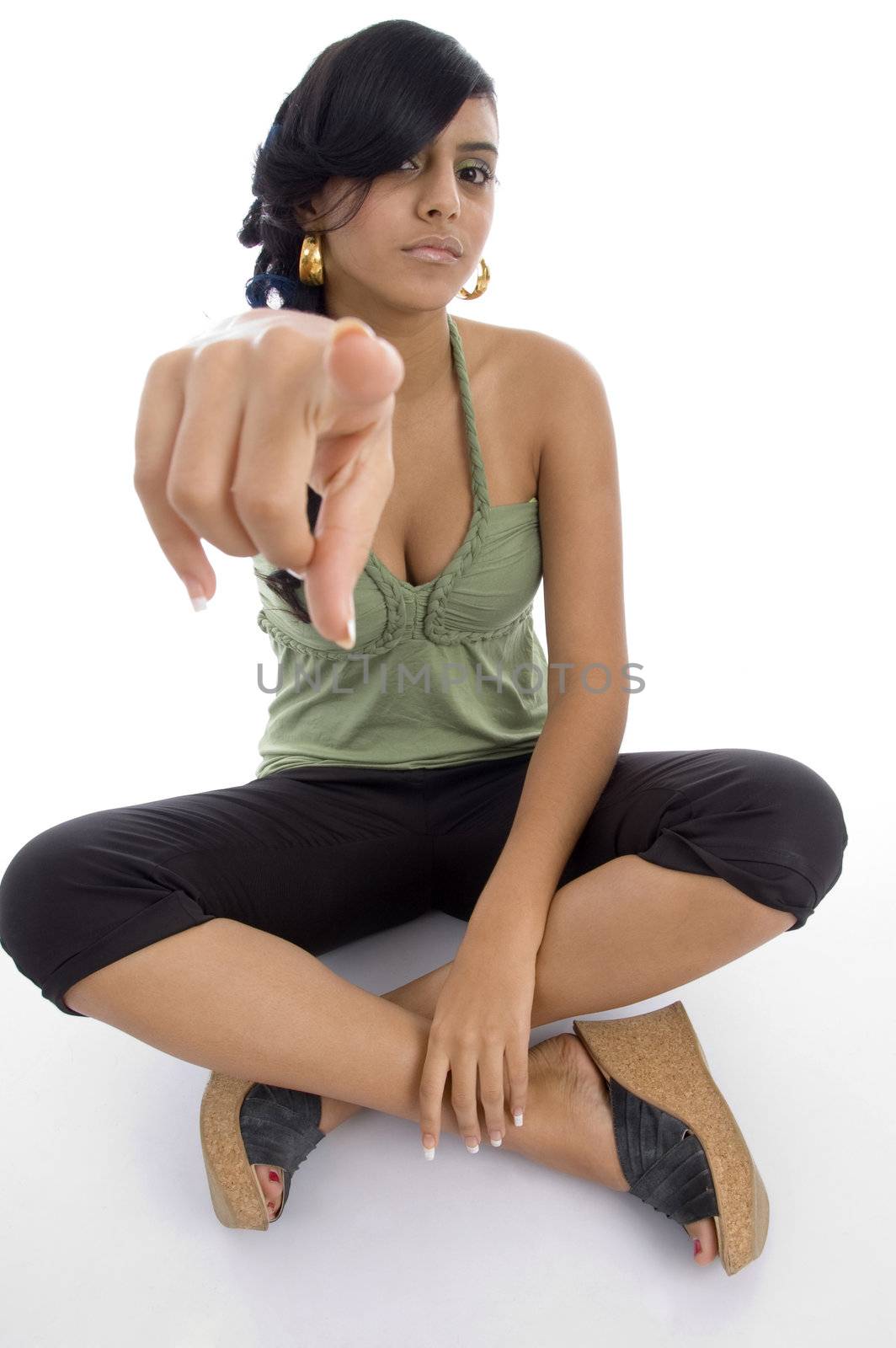 teenager girl pointing towards camera with white background