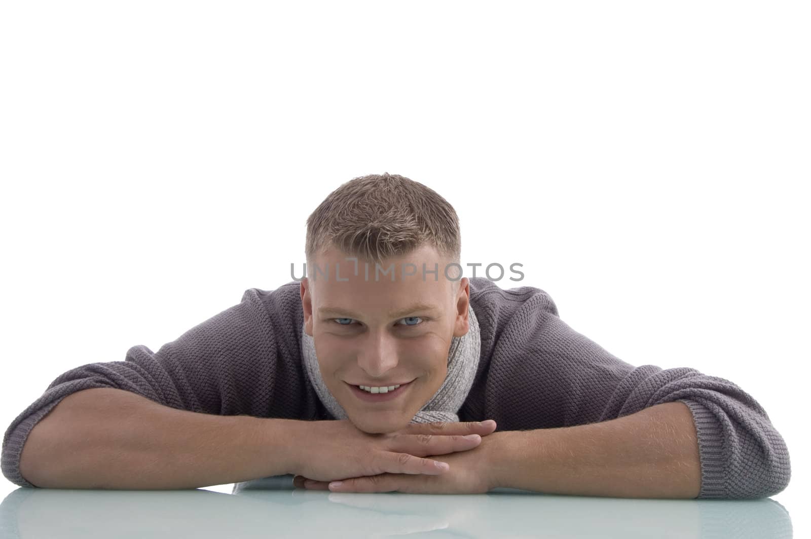 laying handsome male looking at camera on an isolated white background