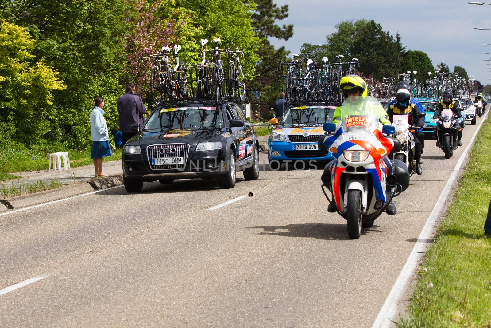 DELFGAUW, NETHERLANDS - MAY 10: Competitors and following teams in the Giro d�Italia passing by on a polderroad in the 3th stage of the competition on May 20, 2010, Delfgauw, the Netherlands. 