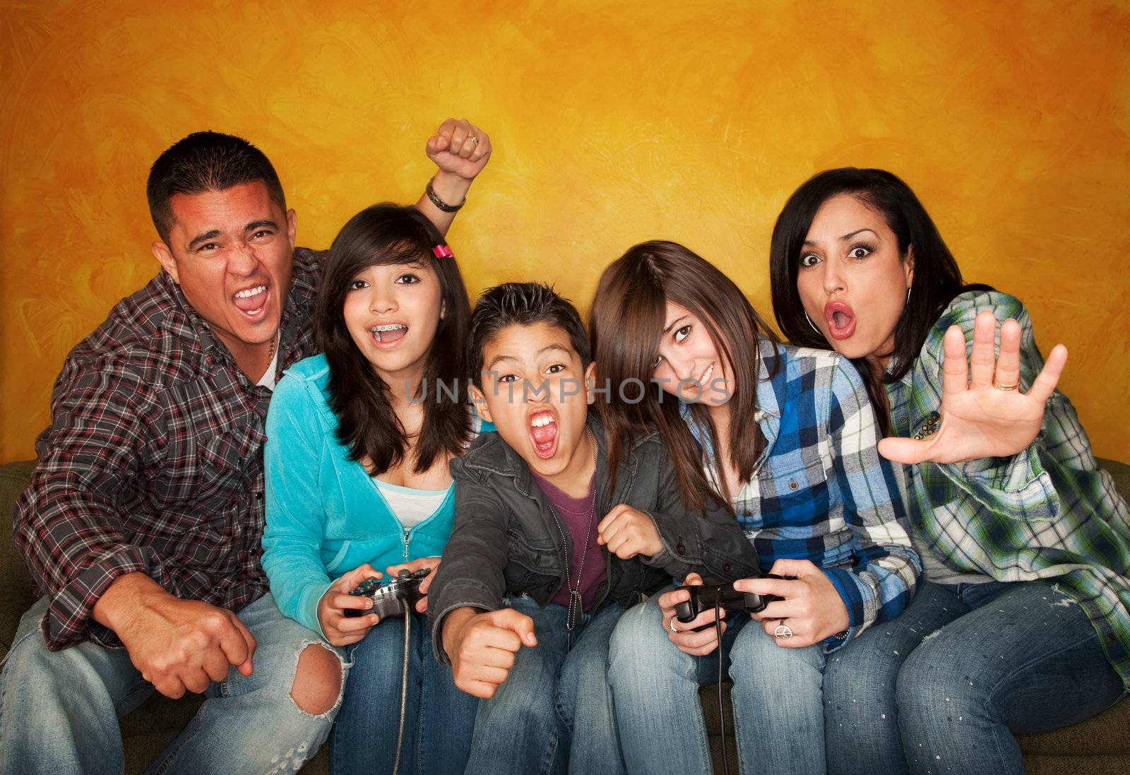 Attractive Hispanic Family on Couch Playing a Video Game