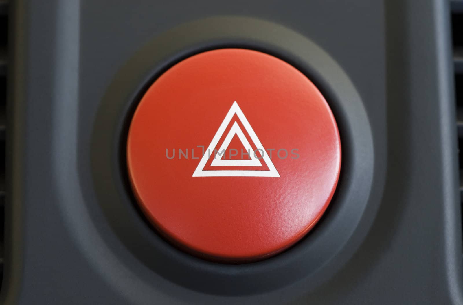 a large red hazard warning light button