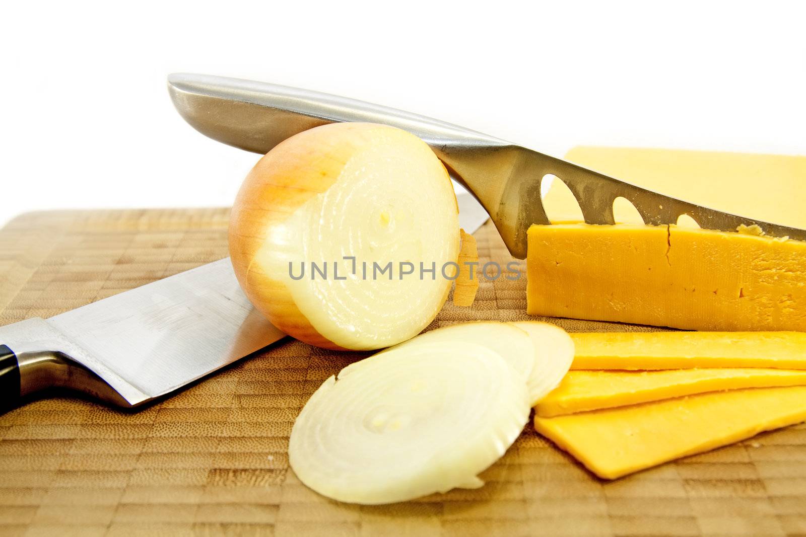 Cheese and Onion with knives on a board