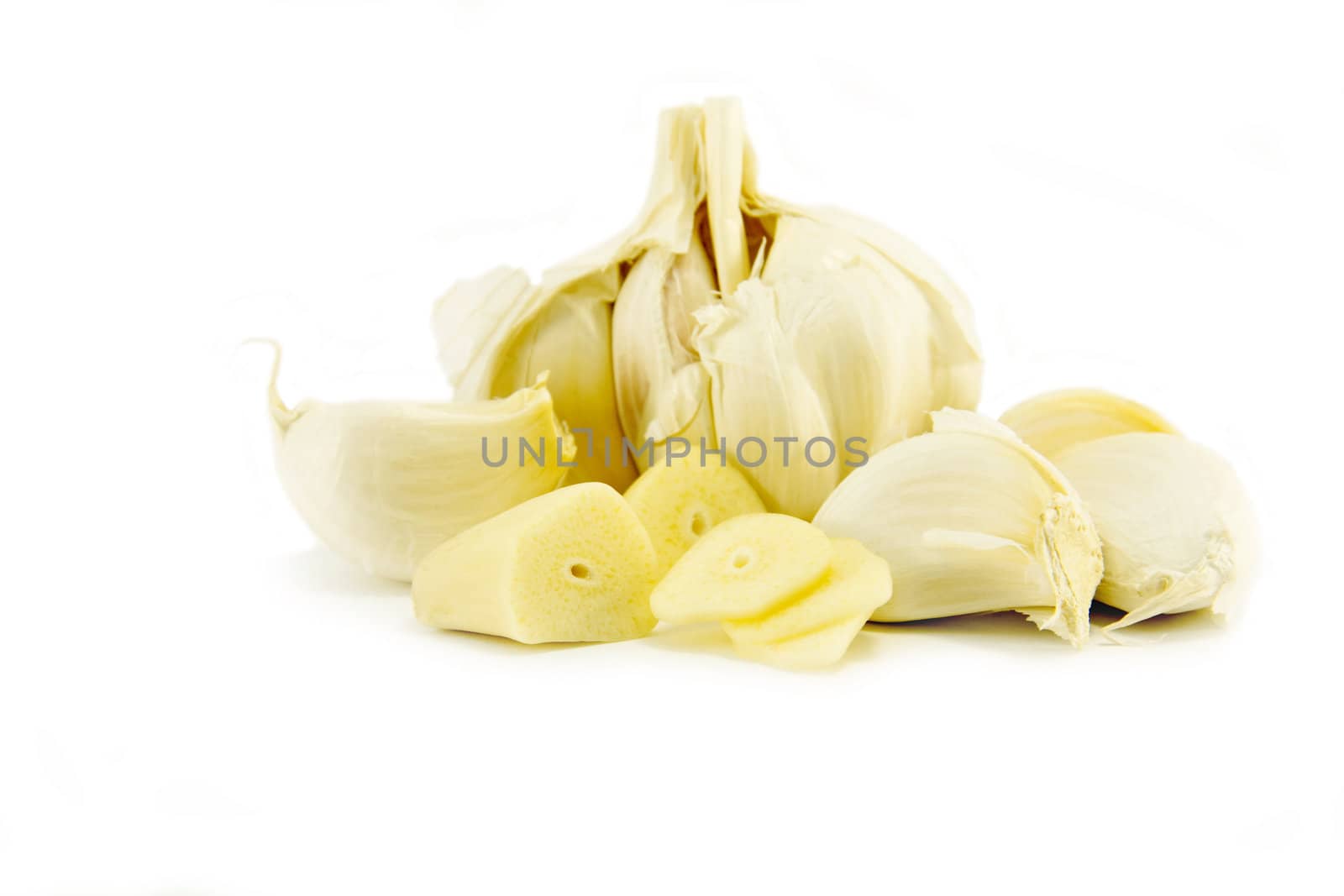 Peeled chopped garlic on white background