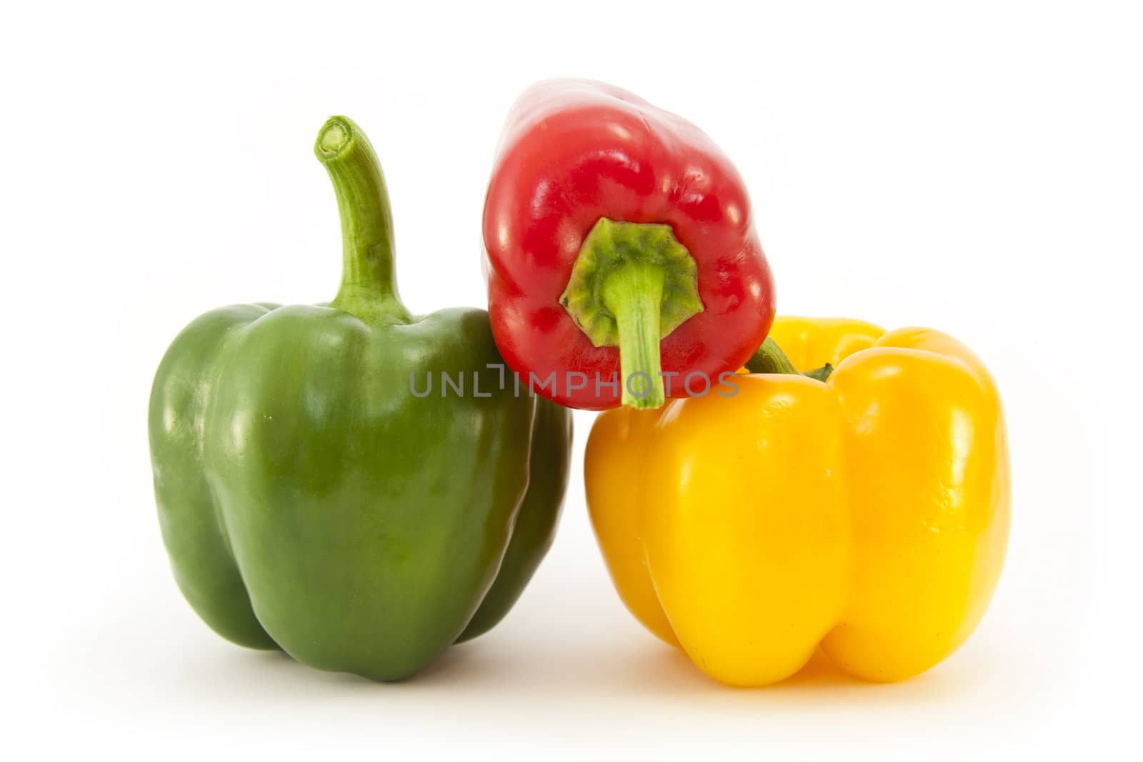 Red, Green and Yellow peppers isolated on white