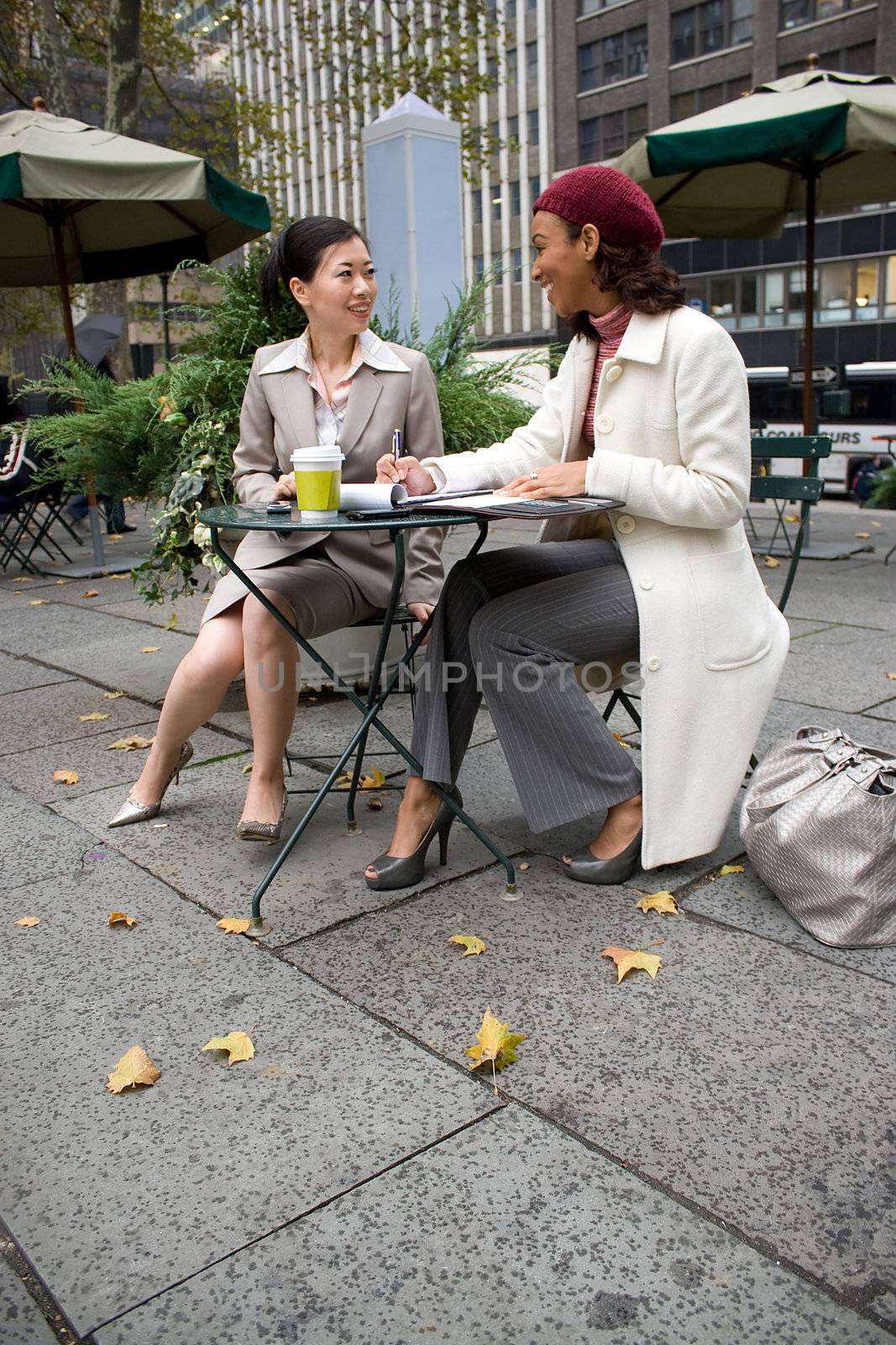 Two business women having a casual meeting in the city.