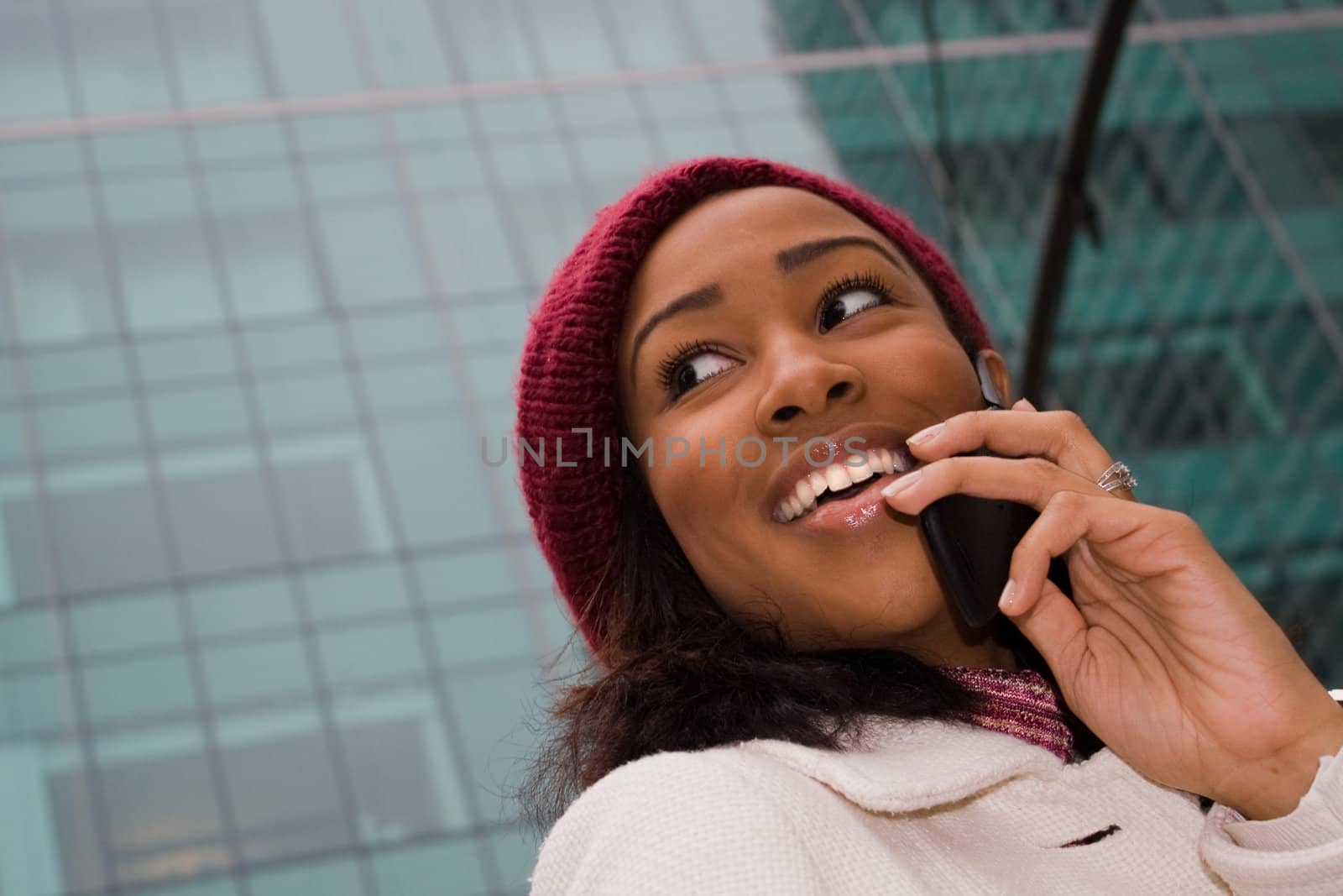 An attractive business woman talking on her cell phone in the city.