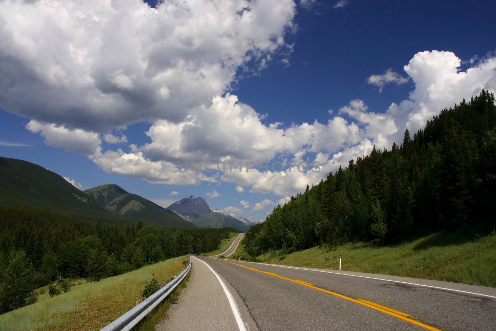 Summer landscape of Kananaskis Country Provincial Park of Alberta, Canada. Empty road.
