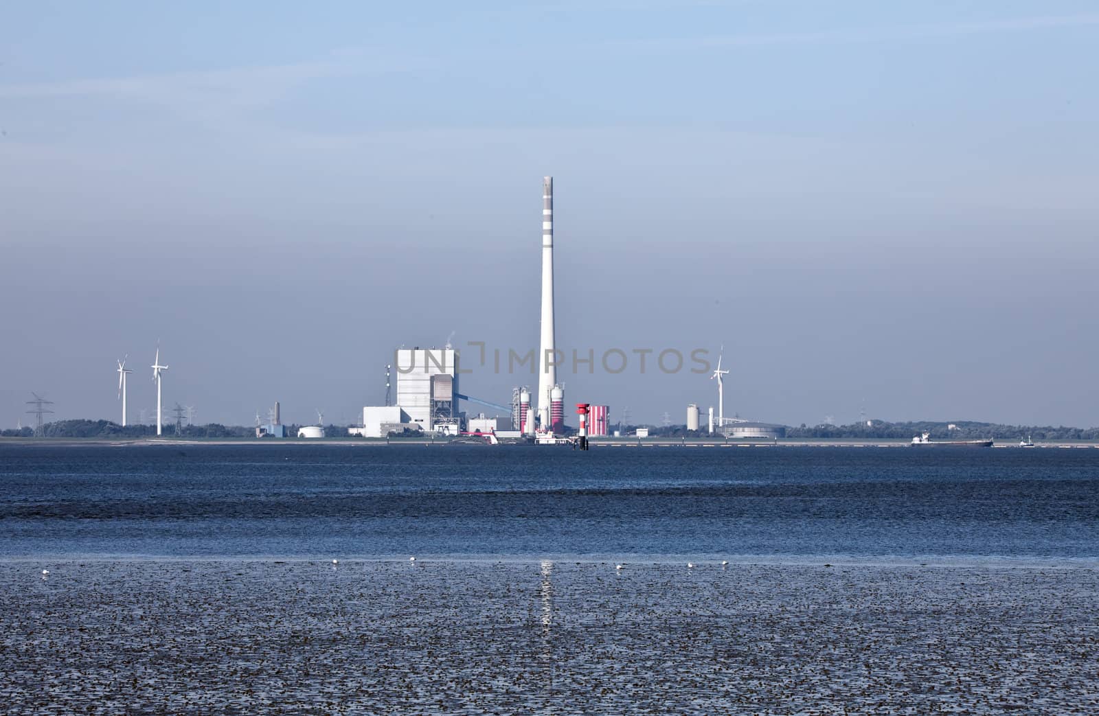 This image shows a industrial plant at north sea mudflat