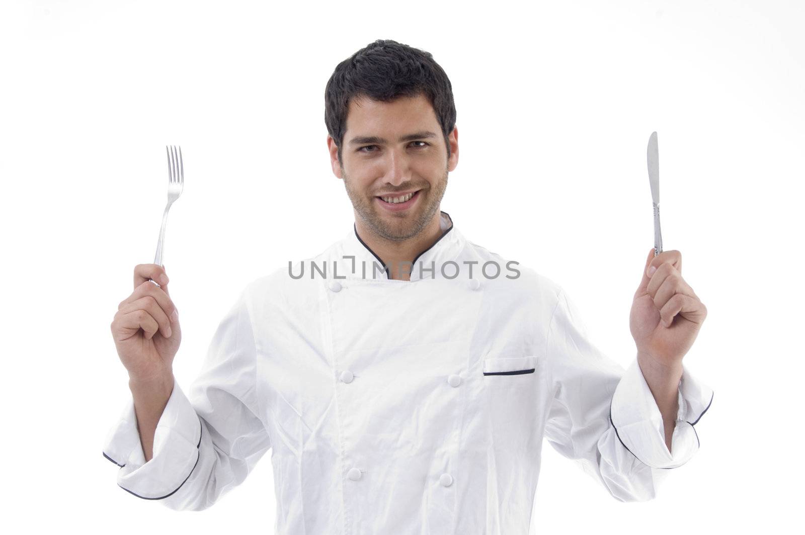 handsome chef holding knife and fork in hands with white background