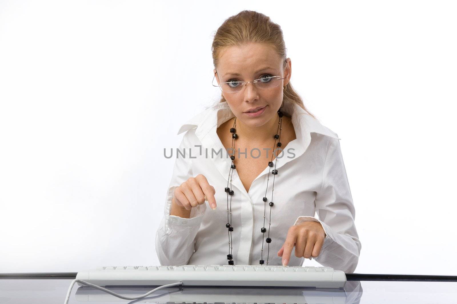 The girl puzzled prints on the keyboard