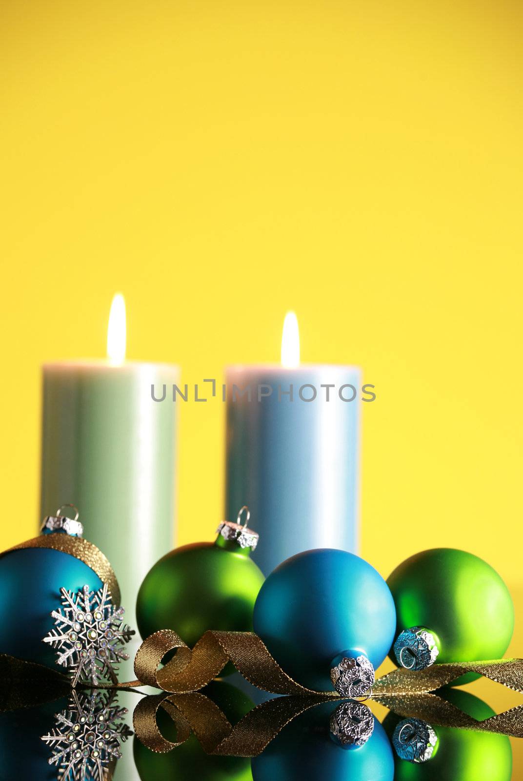 Christmas decorations on yellow background,focus on blue ball and gold ribbon