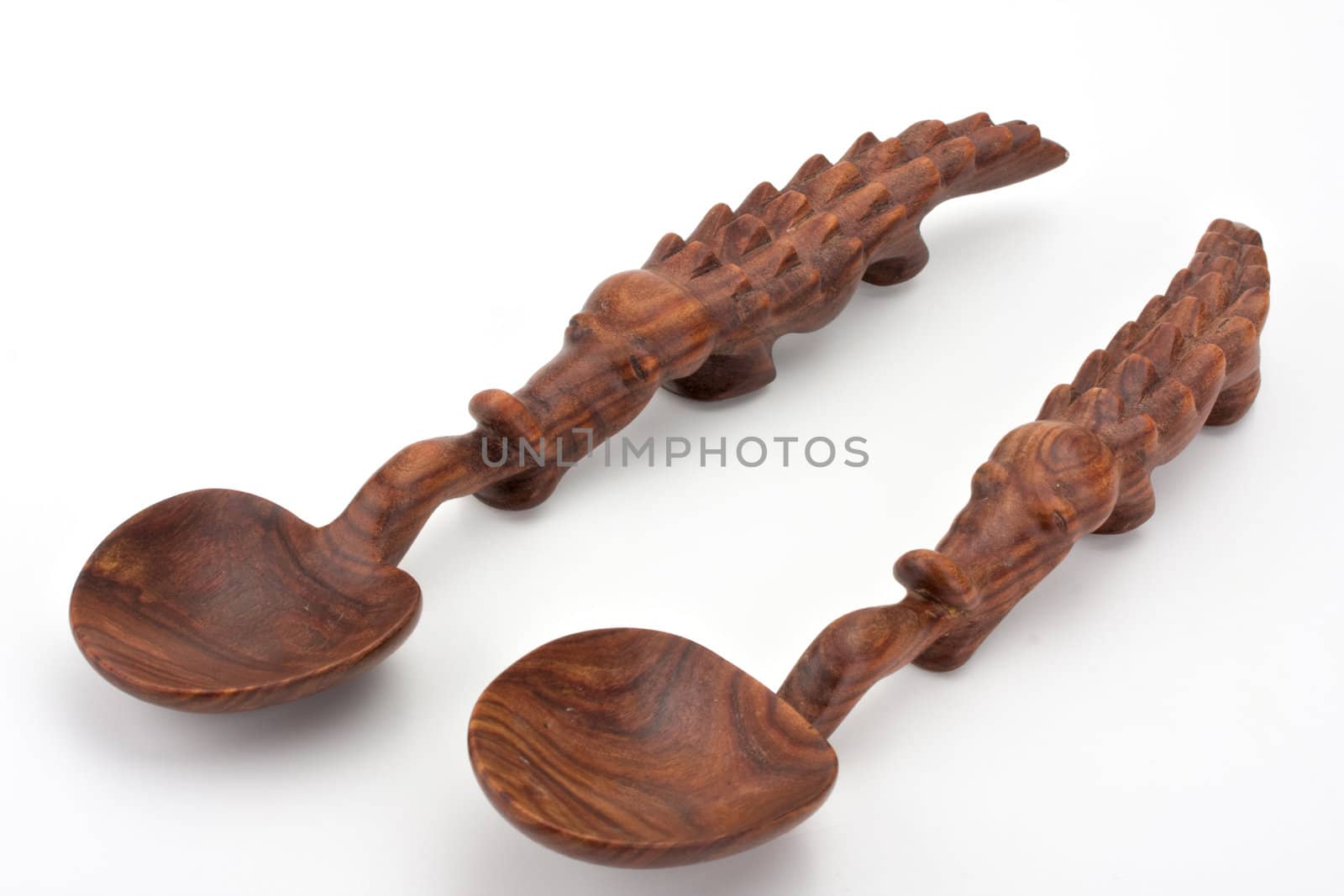a carved spoon in the shape of a crocodile by bernjuer