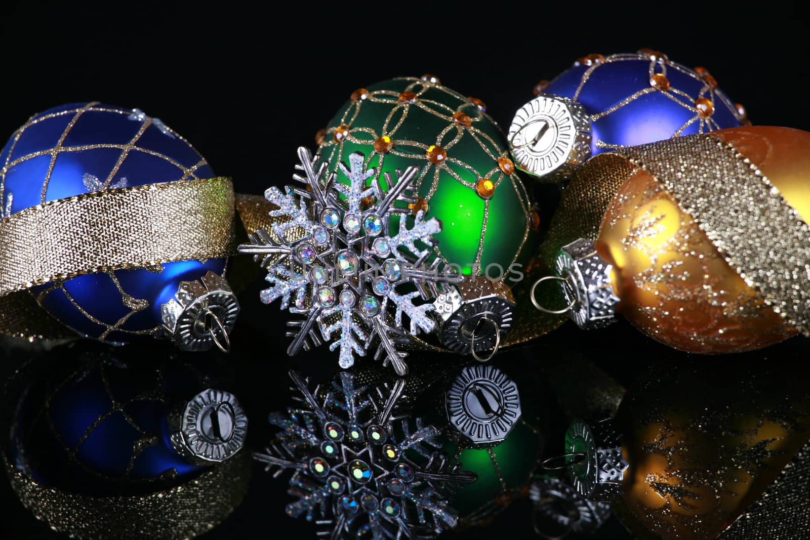 Christmas decorations on black reflective background