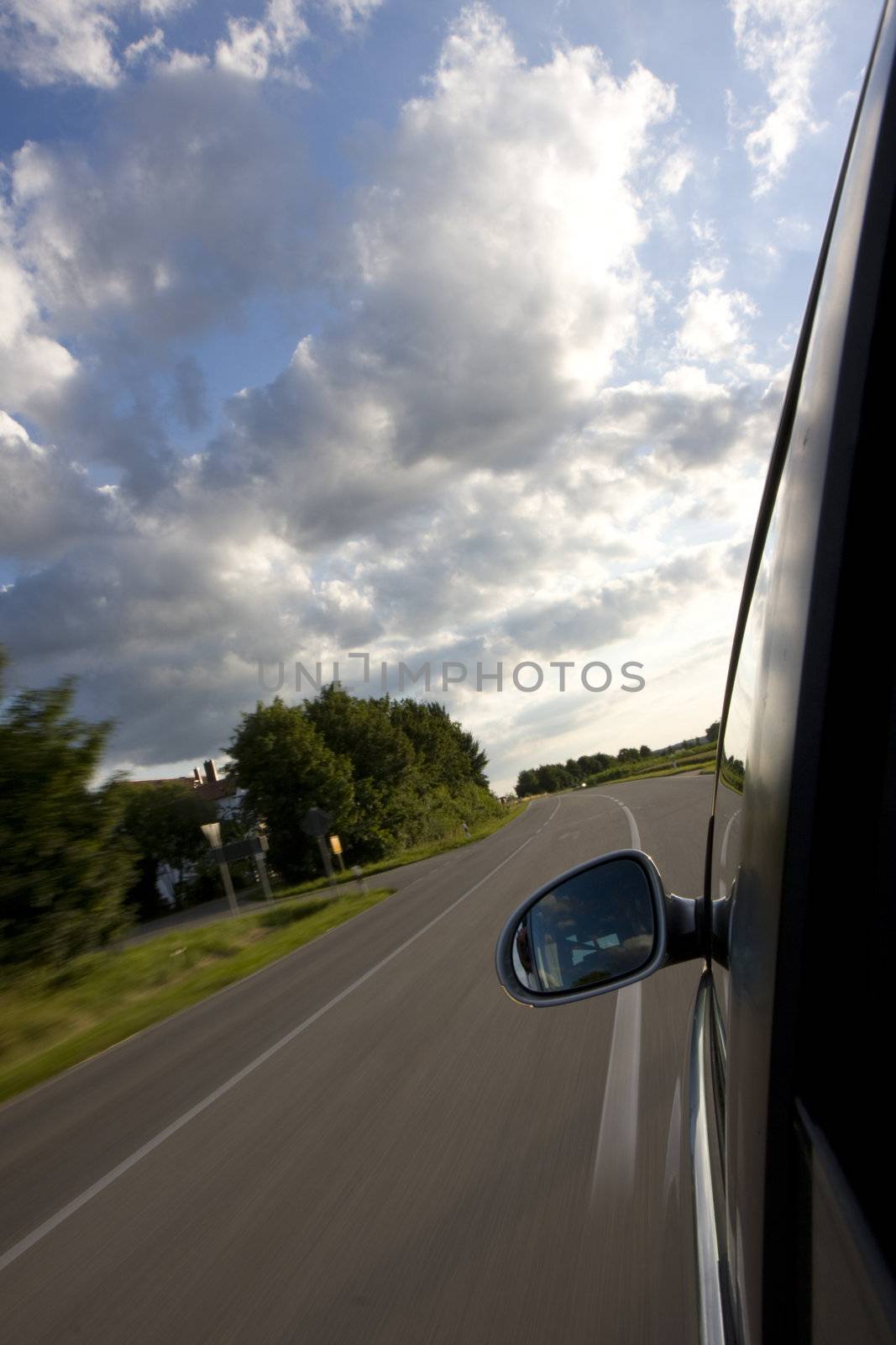 detail of a car driving on a country road by bernjuer