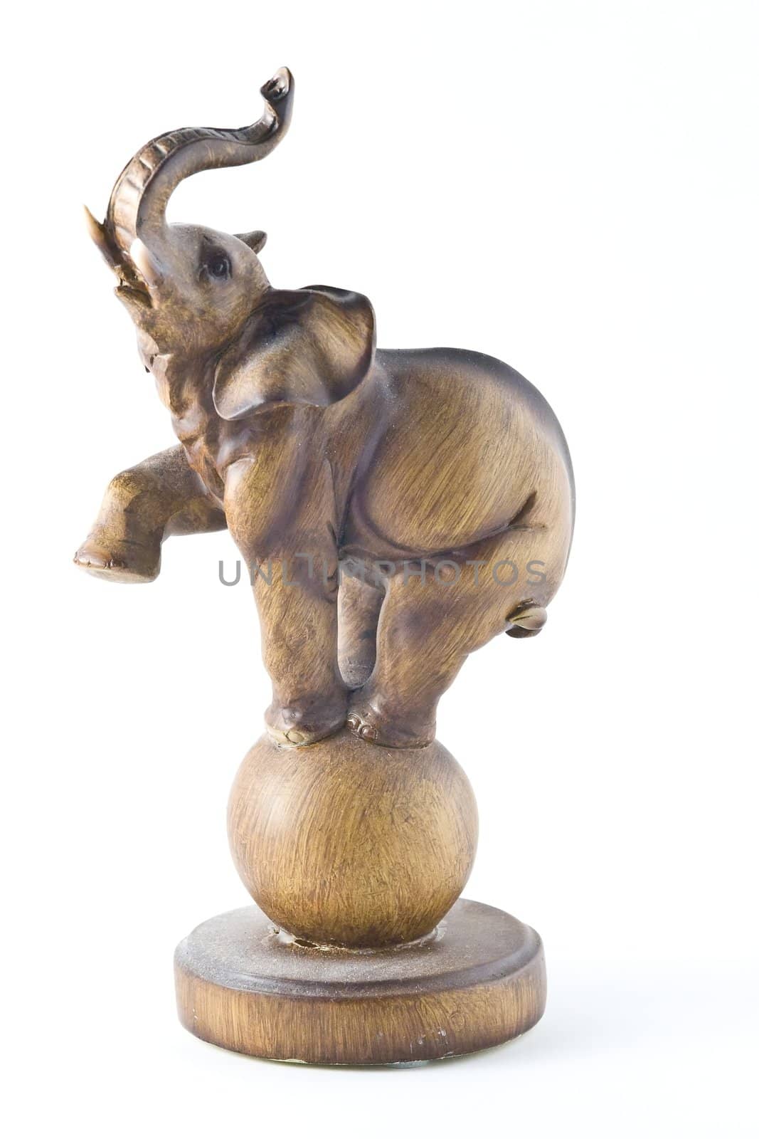 Small wooden elephant statuette on white background