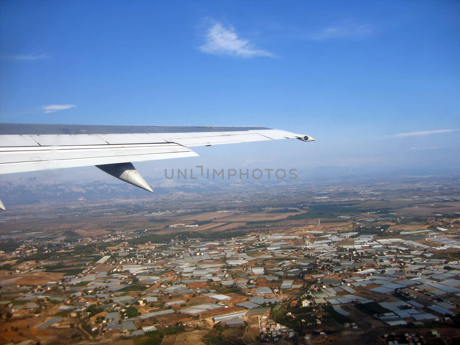 buildings and airplane wing viewing from a plane