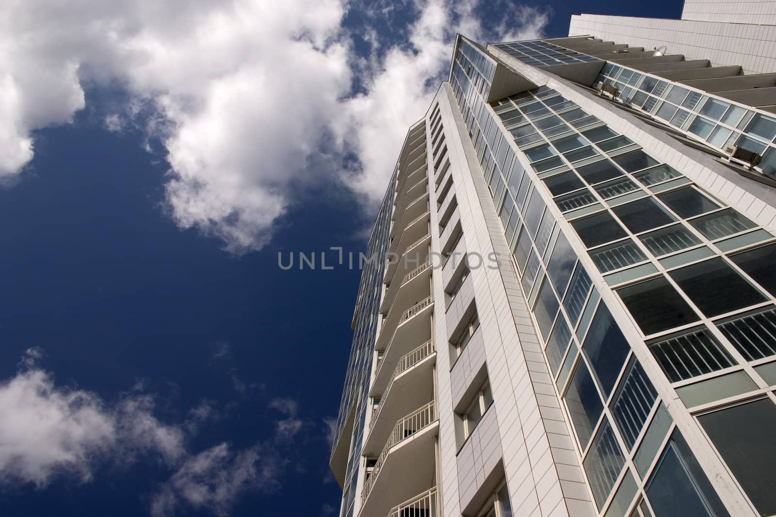 Modern urban building. Glass balconies.
