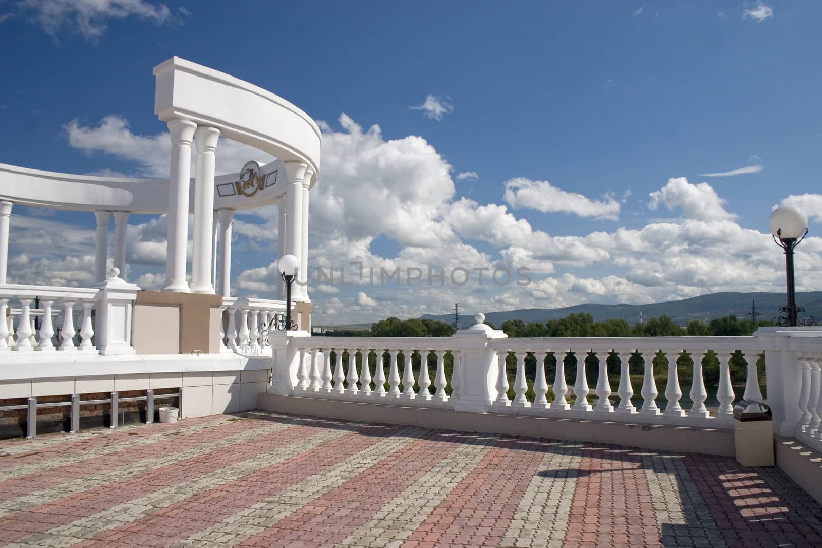 Arch with white columns on a background of the dark blue sky.