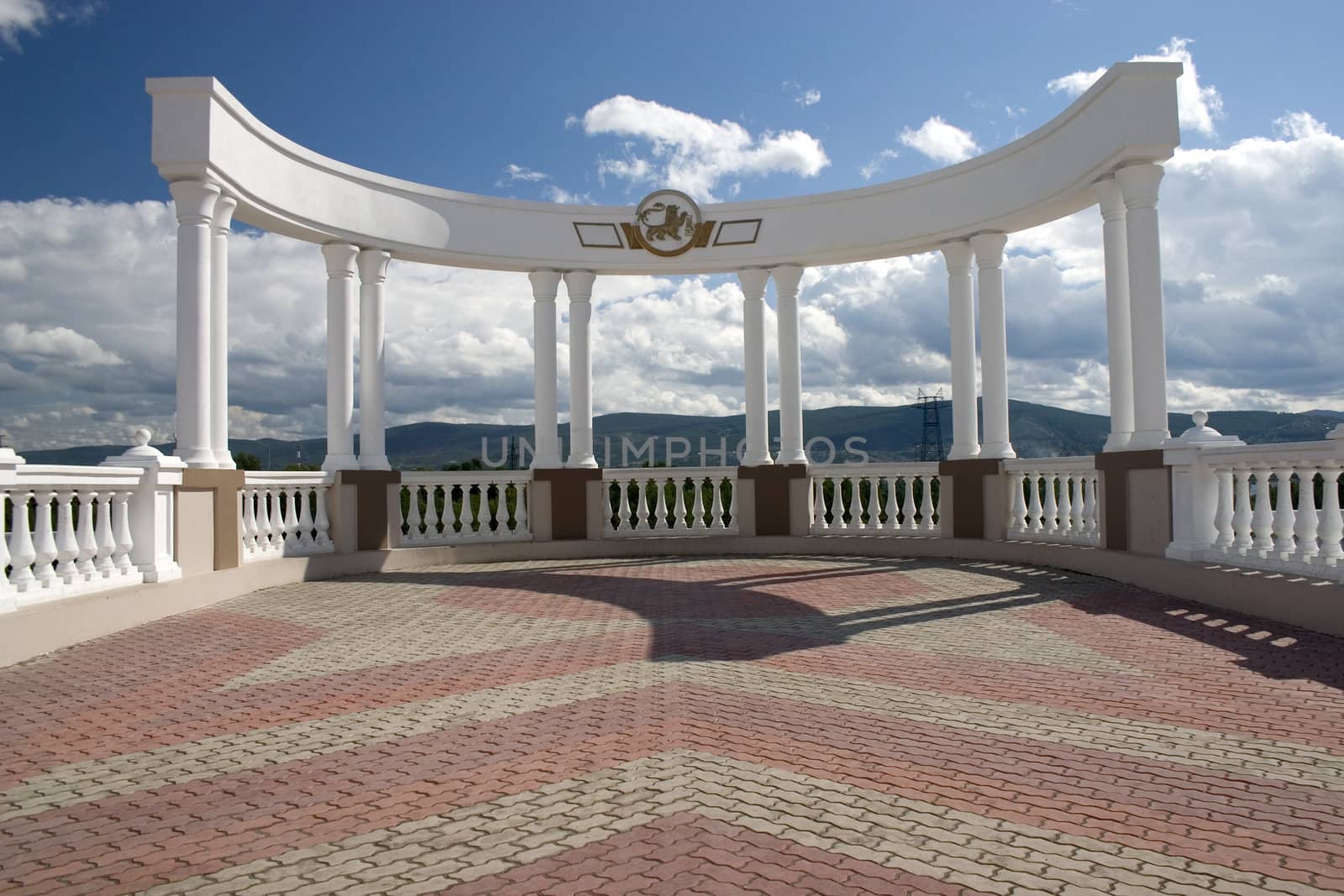 Arch with white columns on a background of the dark blue sky.