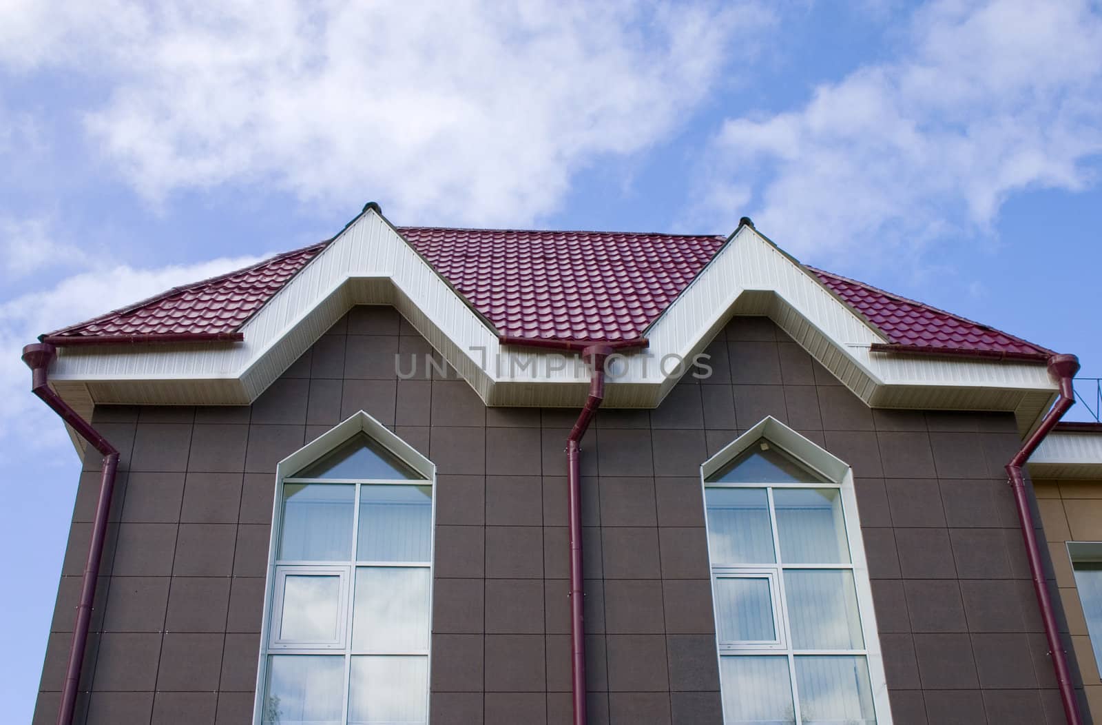 Modern building from a brick. Red tile roof.