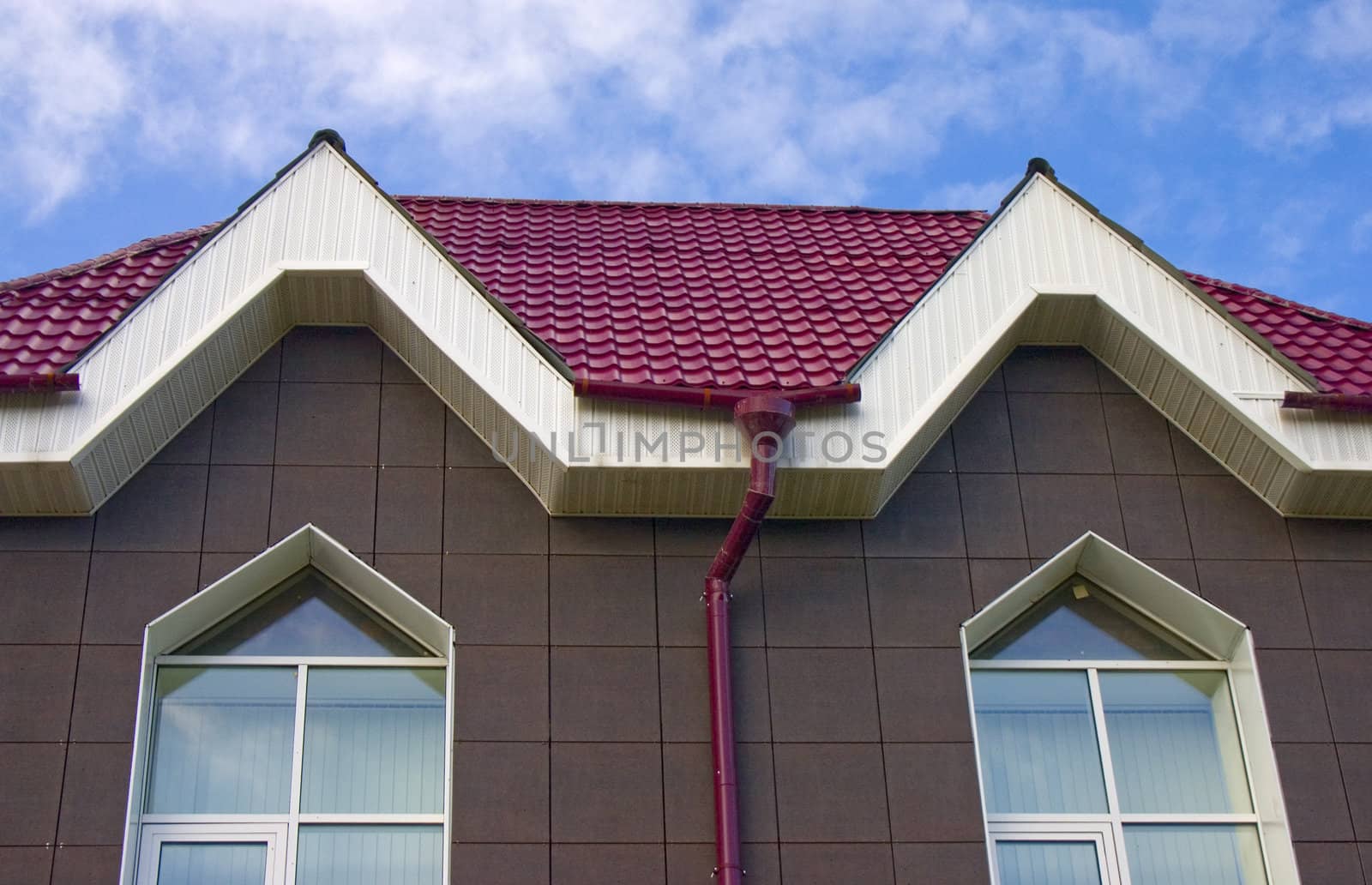 Modern building from a brick. Red roof. A tile.