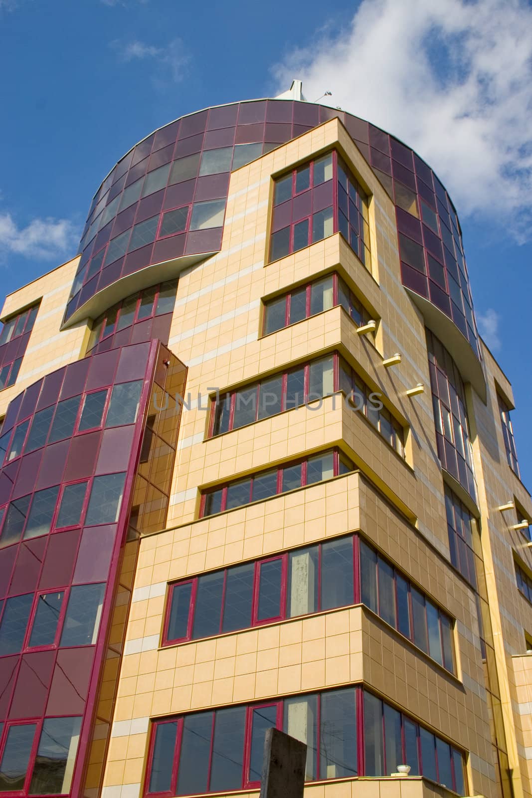 Modern building from a brick. Glass windows and balconies.