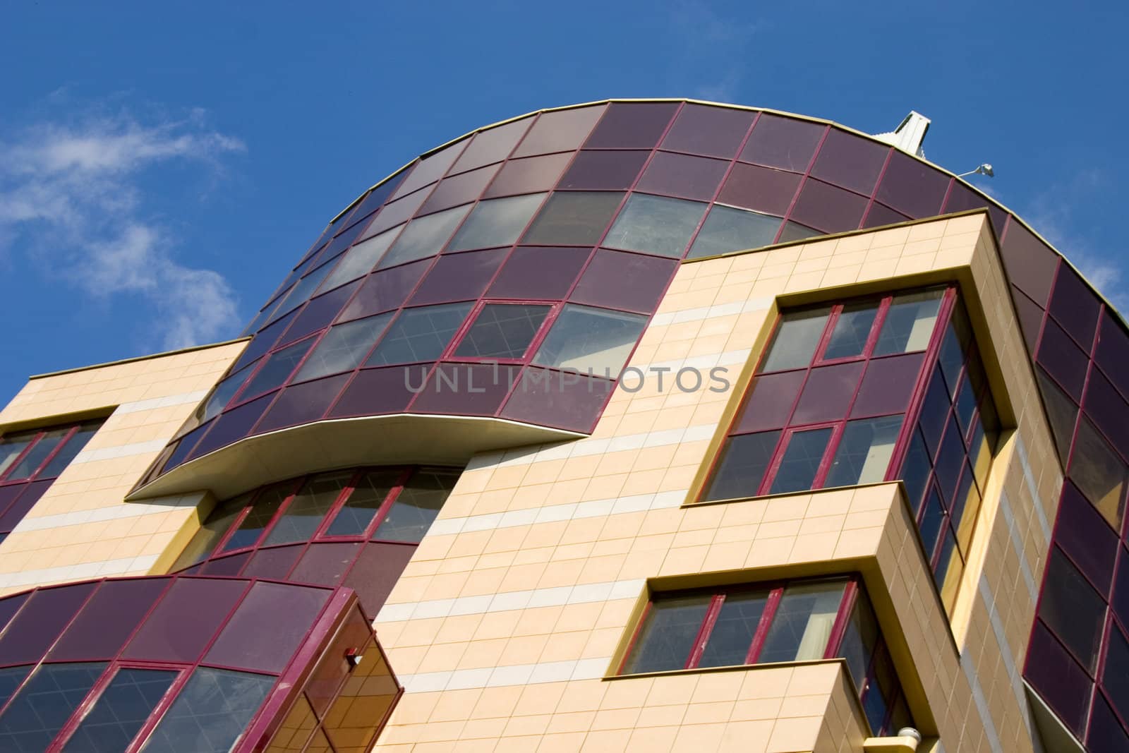Modern building from a brick. Glass windows and balconies.