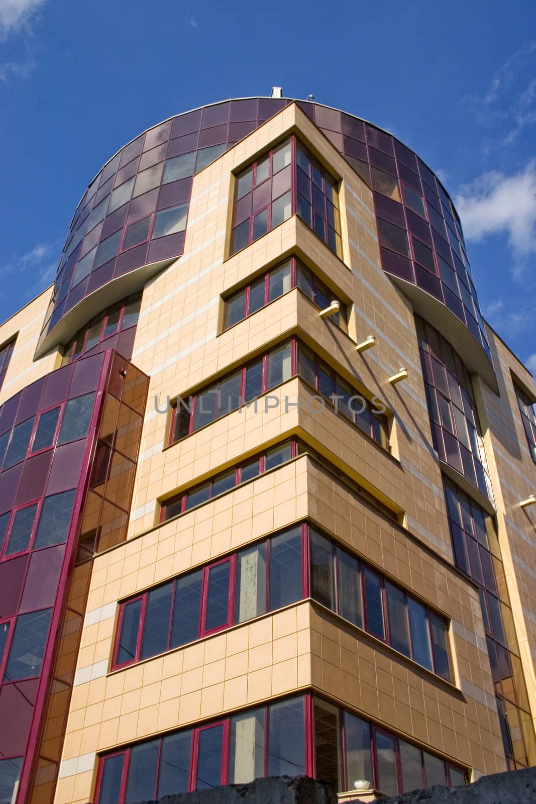 Modern building from a brick. Glass windows and balconies.