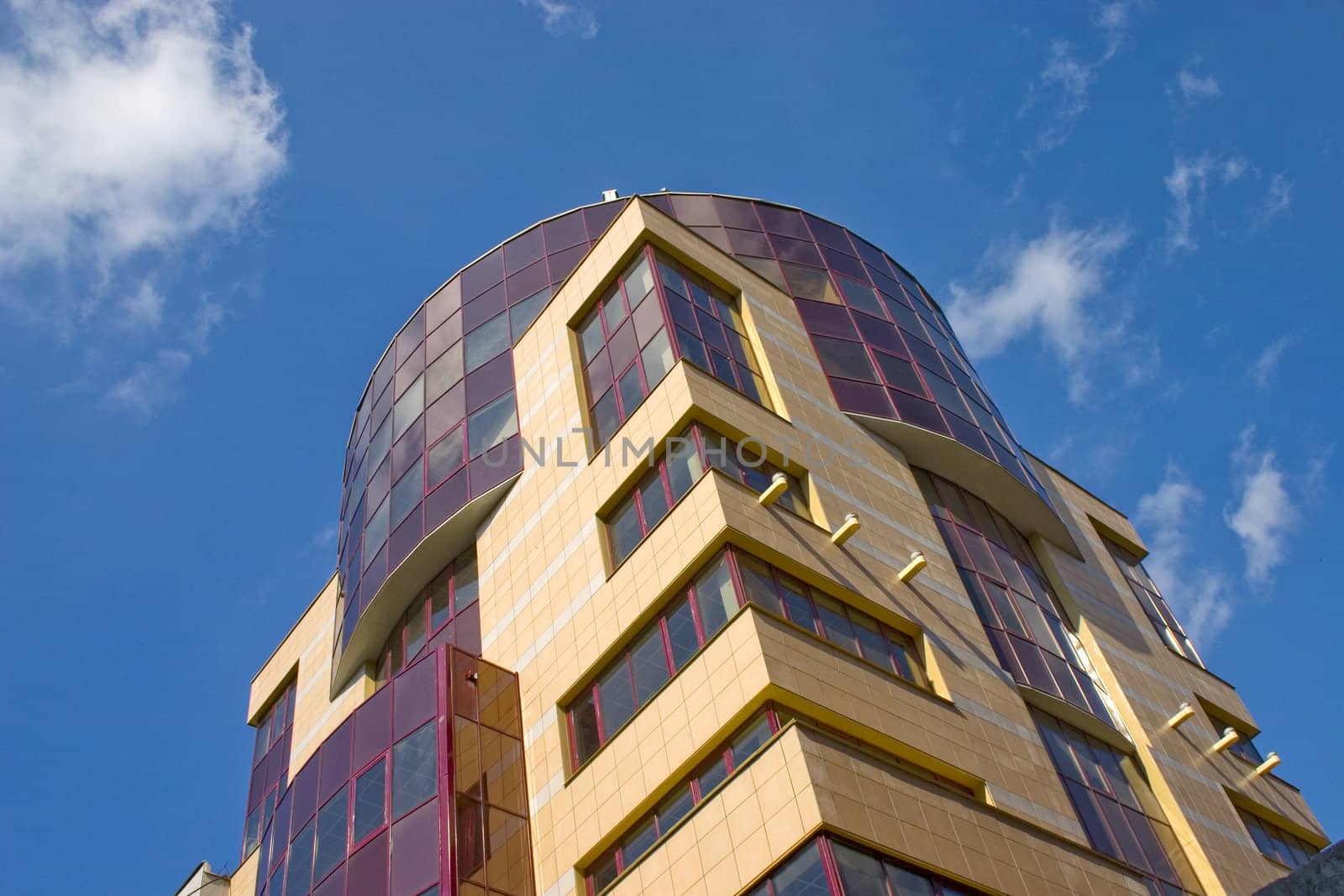 Modern building from a brick. Glass windows and balconies.