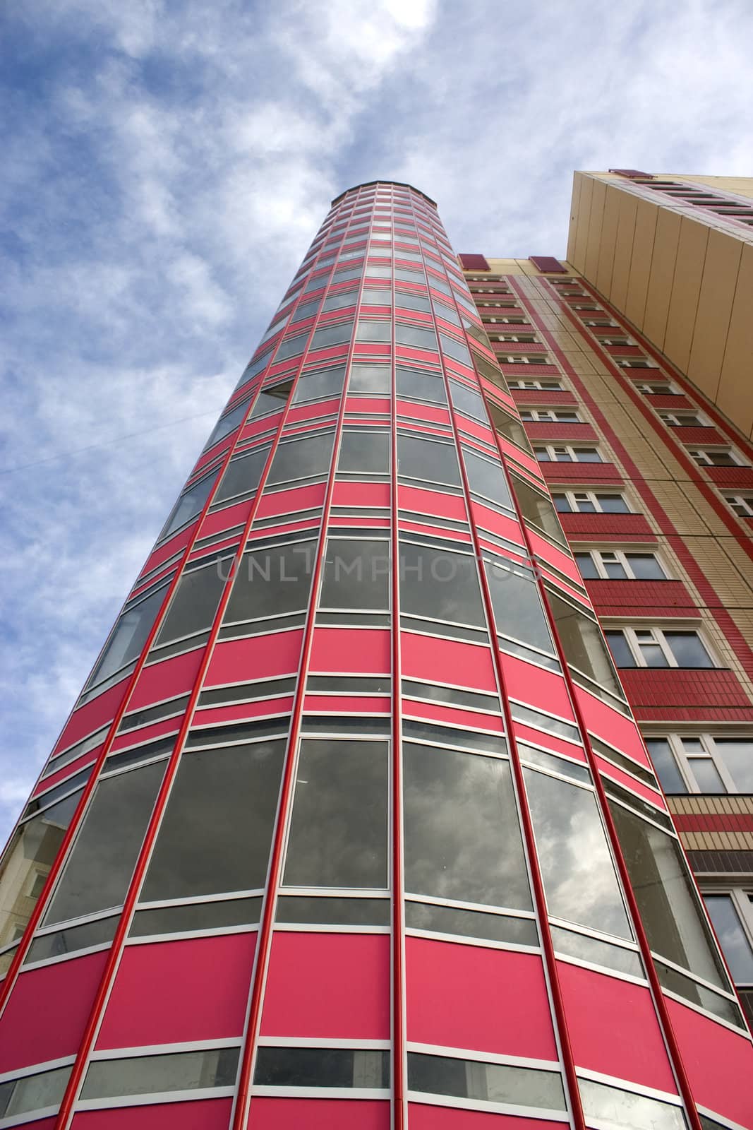 Modern building from a brick. Glass balconies.